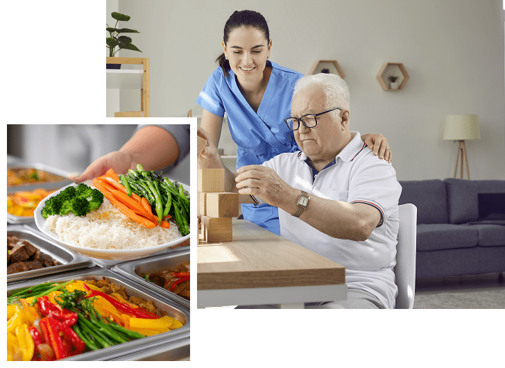 An elderly man with white hair and glasses is sitting at a table, engaging in a tabletop activity with wooden blocks, while a smiling caregiver in a blue uniform stands behind him, offering support. Inset in the lower left corner is a close-up of a tray of colorful, healthy food including rice, broccoli, carrots, green beans, and other vegetables.